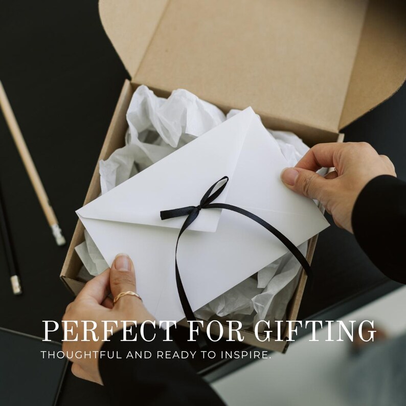 May include: A white envelope tied with a black ribbon inside a cardboard box with white tissue paper. The image includes the text "PERFECT FOR GIFTING" and "THOUGHTFUL AND READY TO INSPIRE".