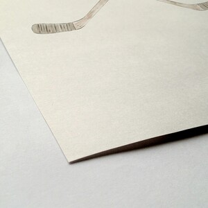 May include: A blank white card with a textured surface. The card is folded in half and the edge is visible.
