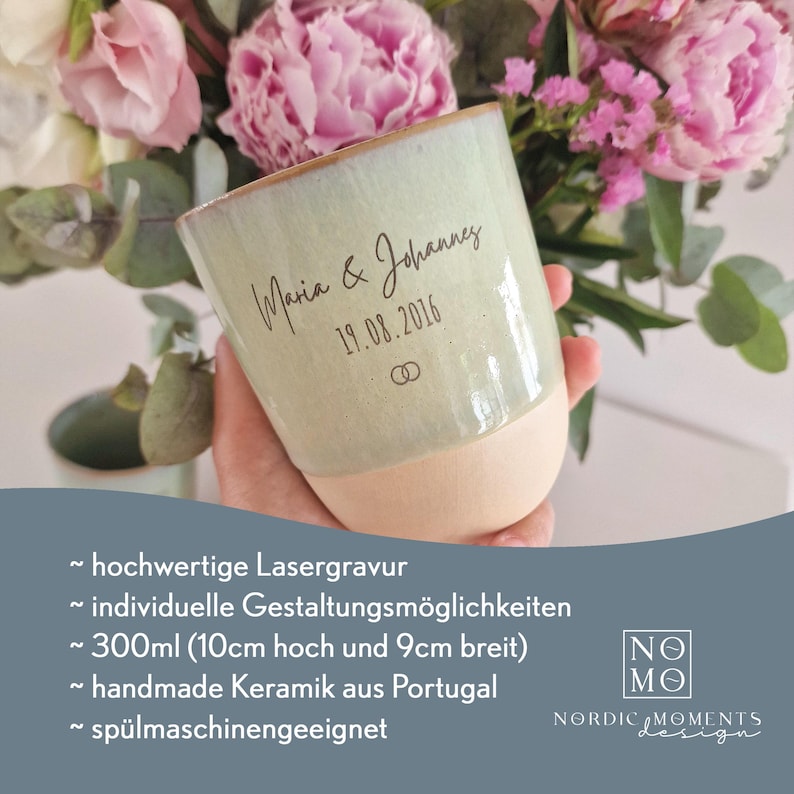 May include: A ceramic mug with a light green glazed upper section and a matte beige base. The mug features the laser-engraved text Maria & Johannes, the date 19.08.2016, and a small double ring icon. It has a 300ml capacity, 10cm height, and 9cm width.