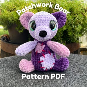 May include: A crocheted patchwork bear made with purple and pink yarn. The bear has large, glittery eyes and a black nose. The text "Patchwork Bear Pattern PDF" is written below the bear.