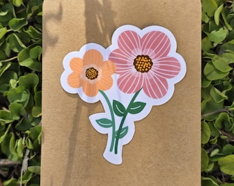 May include: A sticker featuring two flowers, one pink and one orange, with green stems and leaves. The sticker is on a brown background.