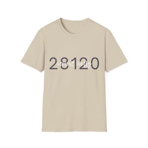 May include: A beige short-sleeved t-shirt featuring the dark gray numbers 28120 printed across the chest. Overlaid on the numbers is the text mount holly written in a white cursive script font. The shirt has a crew neckline and a standard fit.