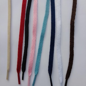 May include: Assortment of eight shoelaces in various colors, including beige, red, black, pink, light blue, navy blue, white, and brown.