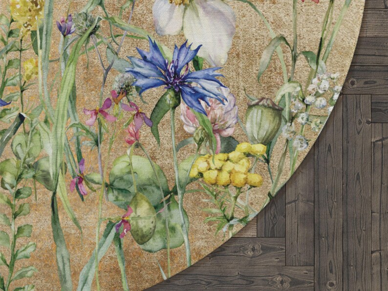 May include: A round rug featuring a watercolour design of assorted flowers and plants on a gold background. The flowers include blue, pink, yellow, and white blooms.