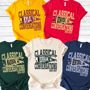 May include: Five short-sleeved t-shirts in various colors: yellow, red, dark green, cream, and navy blue. Each shirt features the text "CLASSICAL CONVERSATIONS" with a city and state name, and the years "2026-2027" in a distressed font.