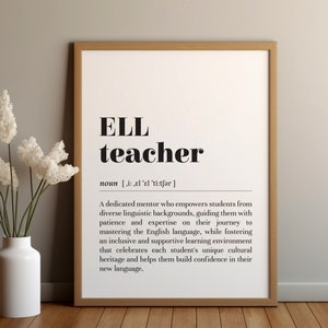 May include: A framed print with the words "ELL teacher" in bold black font. The definition of an ELL teacher is below the title. A white vase with white flowers is to the left of the print.