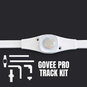 May include: A white Govee Pro Track Kit with a central light fixture and various mounting components. The light fixture has a circular design with multiple small, yellow-toned lights. The text "GOVEE PRO TRACK KIT" is displayed in white.