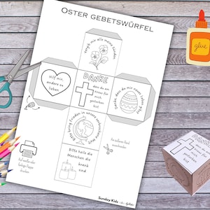 Puede incluir: Una plantilla de cubo de oración de Pascua imprimible con instrucciones para cortar, doblar y pegar. El cubo tiene seis lados con diferentes imágenes y textos, incluyendo una cruz, un corazón, un globo terráqueo, velas, un huevo de Pascua y flores. El texto incluye frases como "Danke dass du am Kreuz für mich gestorben bist" y "Hilf mir, andere zu lieben".