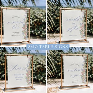 May include: Four 8x10 table signs with gold frames. Each sign has a white background with text and floral accents. The signs read "Mimosa Bar", "Cards and Gifts", "Favors", and "Create Your Own Custom Sign".
