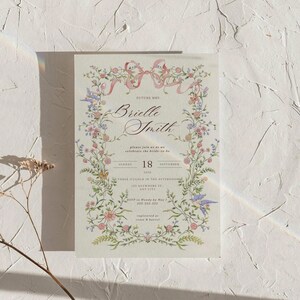 May include: A floral wedding invitation with the text "Future Mrs. Brielle Smith" in elegant script. The invitation features a delicate floral border with pink and purple flowers, and the date "18 September 2010".