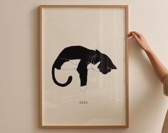May include: A framed art print featuring a stylized black and white illustration of a sleeping cat. The cat is depicted in a relaxed pose, with its body curved and tail curled. The word "zzzz." is printed below the cat.