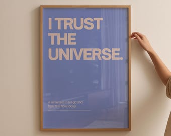 May include: A framed poster with the text "I TRUST THE UNIVERSE" in a light beige font on a blue background. The bottom of the poster reads "A reminder to let go and trust the flow today."
