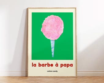 May include: A framed art print featuring a pink cotton candy illustration against a vibrant green background. The words "la barbe à papa" and "cotton candy" are printed in red and black, respectively.