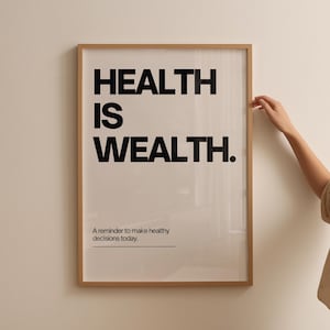 May include: A framed print with the text "HEALTH IS WEALTH." in black bold letters. Below the text is a smaller line of text that reads "A reminder to make healthy decisions today."