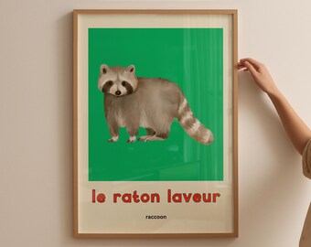 May include: Framed print featuring a raccoon illustration on a green background. The text "le raton laveur" and "raccoon" are below the image. The print is labeled "Instant Download" and "Bilingual Learning Art".