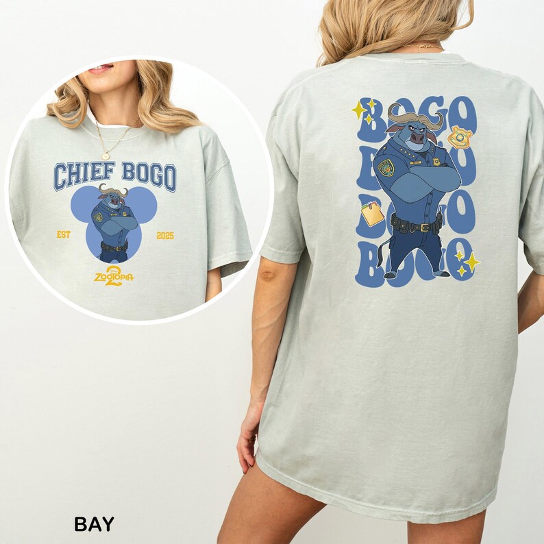 May include: Light green t-shirt featuring a cartoon image of Chief Bogo from Zootopia. The front of the shirt has the text "CHIEF BOGO" and the back has a larger image of the character with the text "BOGO".