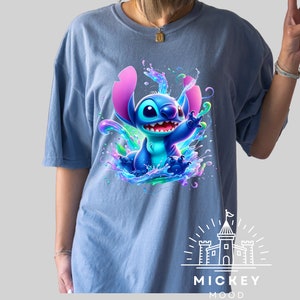 a woman wearing a blue shirt with a stitch stitch stitch stitch stitch stitch stitch stitch