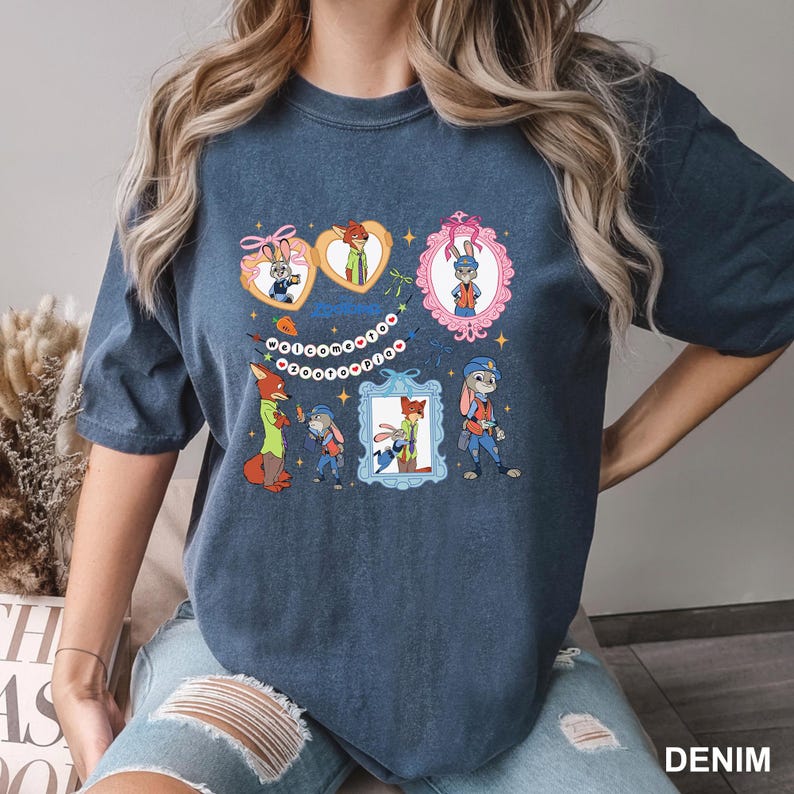 May include: Denim blue t-shirt with cartoon characters in frames and heart shapes. The design includes a fox, a rabbit, and other characters. The word "DENIM" is printed at the bottom right corner of the shirt.