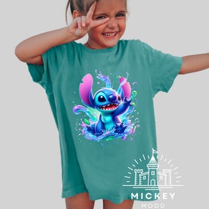 a little girl wearing a blue shirt with a stitch stitch stitch stitch stitch stitch stitch