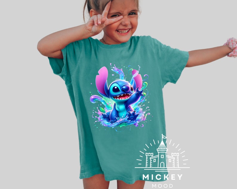 a little girl wearing a blue shirt with a stitch stitch stitch stitch stitch stitch stitch