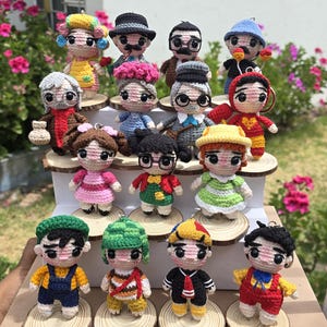 May include: A collection of handmade crochet dolls, each depicting a different character with unique outfits and accessories. The dolls are displayed on small wooden slices, showcasing a variety of colors and designs. The name "ASHLYE RETAMOZO" is visible at the bottom.