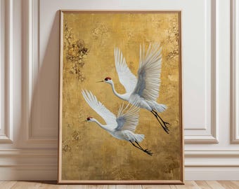 May include: Two white cranes in flight against a gold background. The cranes have red markings on their heads and are flying in formation.