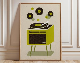May include: A framed art print featuring a retro-style illustration of a record player in shades of green, black, and beige. The record player is depicted with a turntable, and several vinyl records are floating above it. The artwork has a mid-century modern aesthetic.