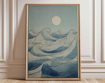 May include: A framed print depicting ocean waves under a pale moon. The artwork features stylized, detailed lines in shades of blue and white, creating a sense of movement and depth. The print is encased in a light brown wooden frame.