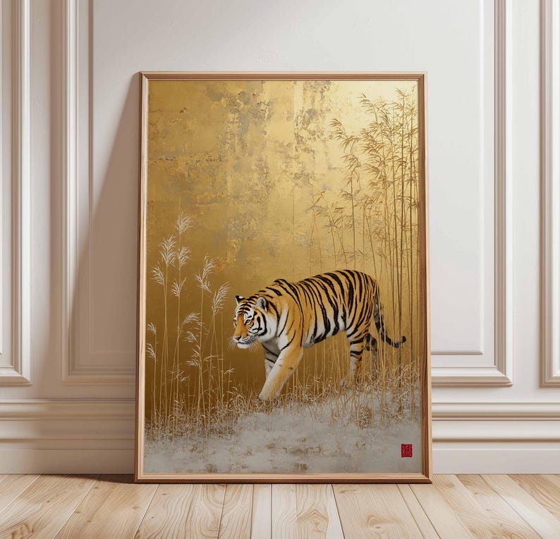 K&ouml;nnte beinhalten: Gerahmtes Kunstwerk mit einem Tiger mit orangefarbenen und schwarzen Streifen, der durch ein Feld mit hohem Gras geht. Der Hintergrund ist goldfarben strukturiert mit Bambusst&auml;ngeln. Das Kunstwerk befindet sich in einem Holzrahmen.