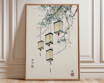 May include: A framed print featuring a traditional Asian-inspired illustration. The artwork depicts hanging lanterns with red tassels suspended from tree branches with green leaves. The lanterns are rectangular with a light yellow glow.