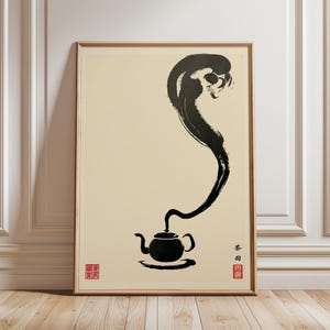 May include: A framed art print featuring a minimalist ink wash painting of a teapot with steam rising upwards. The artwork is primarily black on a cream background, with Japanese characters and red stamps.