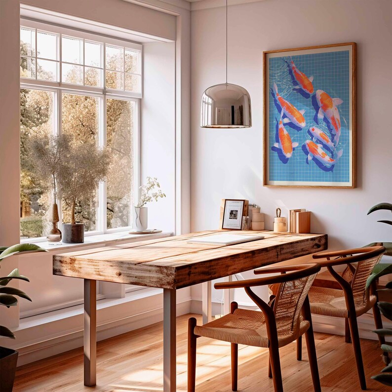 May include: A light and spacious room featuring a wooden desk and two chairs. A framed artwork of koi carp adorns the wall. A large window provides a view of trees. A silver pendant light hangs above the desk.