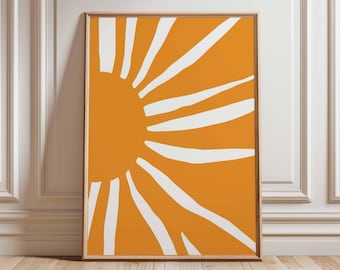 Könnte beinhalten: Ein gerahmter Kunstdruck mit abstraktem Design. Das Kunstwerk zeigt einen leuchtend orangefarbenen Hintergrund mit weißen, sonnenstrahlenartigen Formen, die von links ausstrahlen. Der Druck ist in einem einfachen Holzrahmen für Wanddekoration.