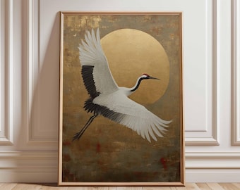 May include: Framed artwork featuring a Japanese crane in flight against a golden sun. The crane has white feathers with black wingtips and a red crown. The background has a textured, gold and brown color palette. The artwork is displayed in a wooden frame.