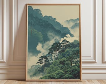 May include: A framed art print showing a misty mountain scene. The artwork displays layers of green trees and blue-green mountains, partially hidden by white clouds. The print is in a wooden frame.
