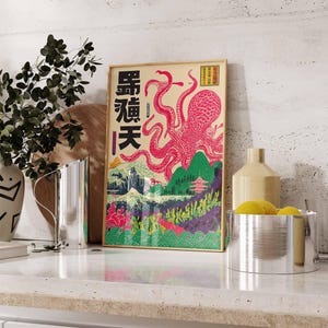 May include: Framed art print featuring a pink octopus with Japanese text and landscape elements. The artwork has a vintage aesthetic with a beige background and a wooden frame. The octopus is the focal point, with its tentacles reaching across the image.