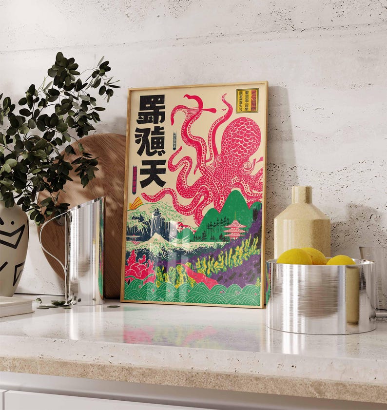 May include: Framed art print featuring a pink octopus with Japanese text and landscape elements. The artwork has a vintage aesthetic with a beige background and a wooden frame. The octopus is the focal point, with its tentacles reaching across the image.