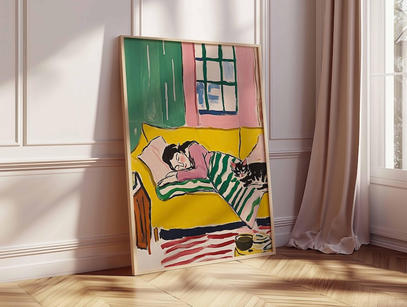 May include: A painting depicting a woman asleep on a yellow sofa with a cat sitting on the sofa. The woman is wearing a pink shirt and a green and white striped blanket. The cat is black and white. The painting is set in a room with a pink wall and a green window.
