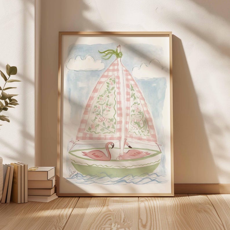 May include: Watercolor painting of a sailboat with a pink and white checkered sail adorned with floral patterns. Two pink flamingos rest in the green boat. The background features a blue sky with white clouds.