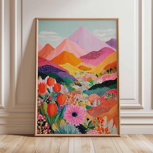 May include: A framed art print showcasing a colourful landscape painting. The artwork features mountains in pink, orange, and purple, with a foreground of flowers. The painting is set against a light blue sky, creating a vibrant and cheerful scene.