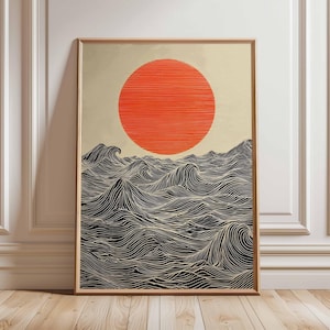 Puede incluir: Impresión artística enmarcada que representa una escena oceánica estilizada. La obra muestra un gran sol naranja sobre olas negras y blancas, creadas con líneas curvas detalladas. La impresión está en un marco de madera.