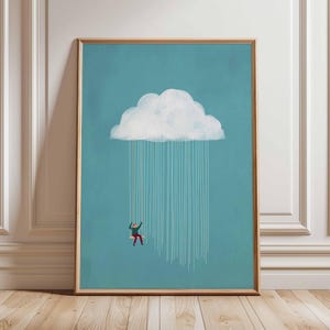 Puede incluir: Impresión artística enmarcada con una ilustración caprichosa. Una persona con ropa roja y verde se balancea de una nube, con líneas de lluvia descendentes. El fondo es turquesa y el marco es marrón claro.