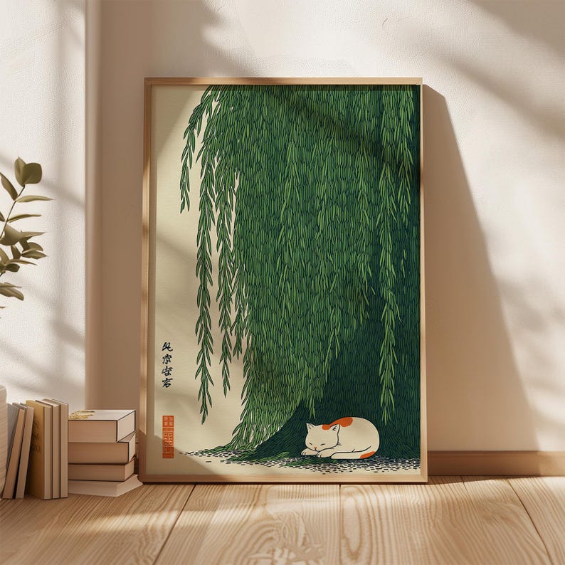 May include: A framed art print featuring a sleeping cat under a weeping willow tree. The artwork has a Japanese aesthetic, with a white and orange cat resting on the ground beneath the green foliage. The print includes Japanese text.