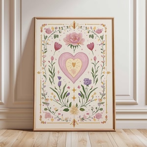 May include: A framed art print featuring a central heart design with a smaller heart inside, surrounded by floral elements. The artwork includes pink roses, purple tulips, and other flowers, with gold accents on a cream background. The frame is a warm brown color.