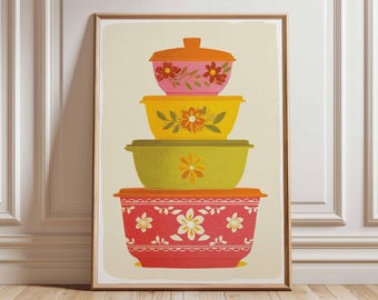 May include: A framed print depicting a stack of four retro-style bowls with lids. The bowls are in pink, yellow, and green, each decorated with floral designs. The base bowl is red with white flowers, evoking a vintage aesthetic.
