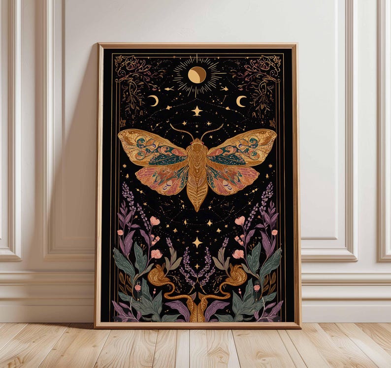 May include: A framed art print featuring a large moth with intricate wing patterns in shades of gold, pink, and teal against a black background. The artwork includes celestial elements like the moon, stars, and floral accents, framed in a wooden border.