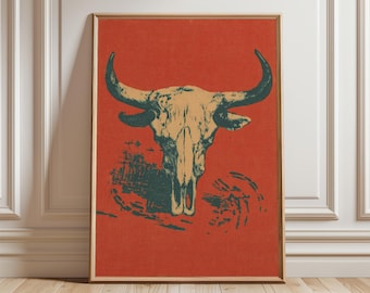 May include: Framed art print featuring a bull skull illustration. The skull is in shades of beige and green, set against a vibrant red background. The artwork is framed in a natural wood tone, adding a rustic touch to the decor.