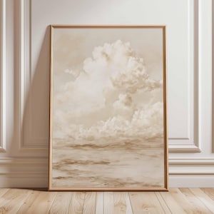 May include: A framed art print featuring a serene landscape with a cloudy sky. The artwork is dominated by shades of beige and brown, creating a soft, muted aesthetic. The wooden frame adds a touch of warmth to the overall composition.