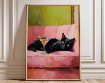May include: A framed art print shows a black cat relaxing on a pink sofa, with a martini glass in front. The cat has yellow eyes. The background is a green and gold abstract design. The artwork is framed in a gold-colored frame.