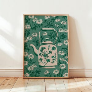 May include: A rectangular wall art print featuring a light-coloured teapot centred against a dark green background. The teapot is decorated with a floral pattern, and the surrounding background is filled with a repeating pattern of white daisies.